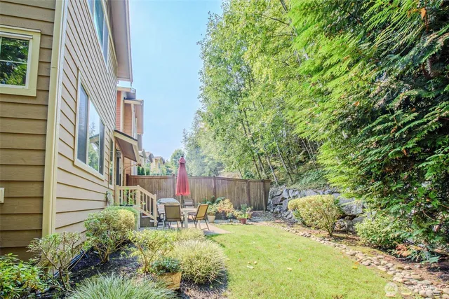 a view of backyard with patio and outdoor seating