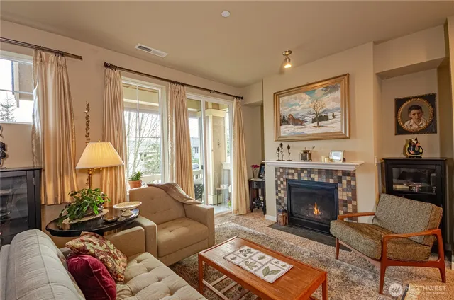 a living room with furniture a window and a fireplace