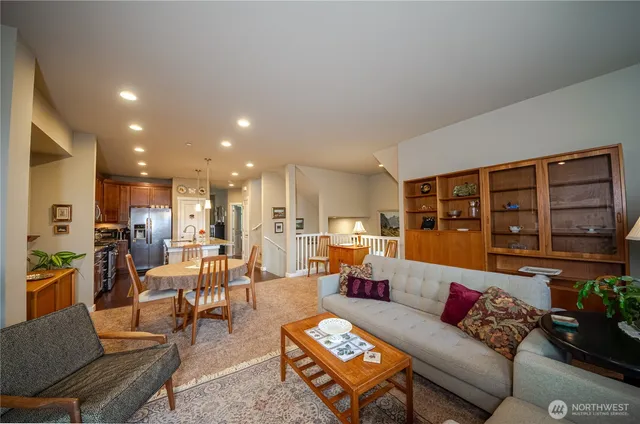 a living room with furniture and kitchen view