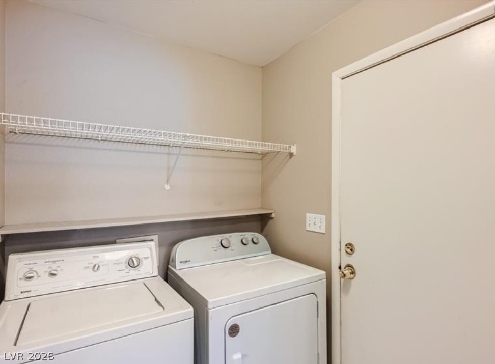 3950 South Sandhill Road, Unit 121 Las Vegas, NV 89121 - Photo 3 of 11 Functional laundry space featuring convenient shelving and essential appliances.