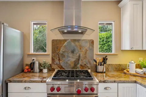 a view of a dining room with furniture large windows and wooden floor