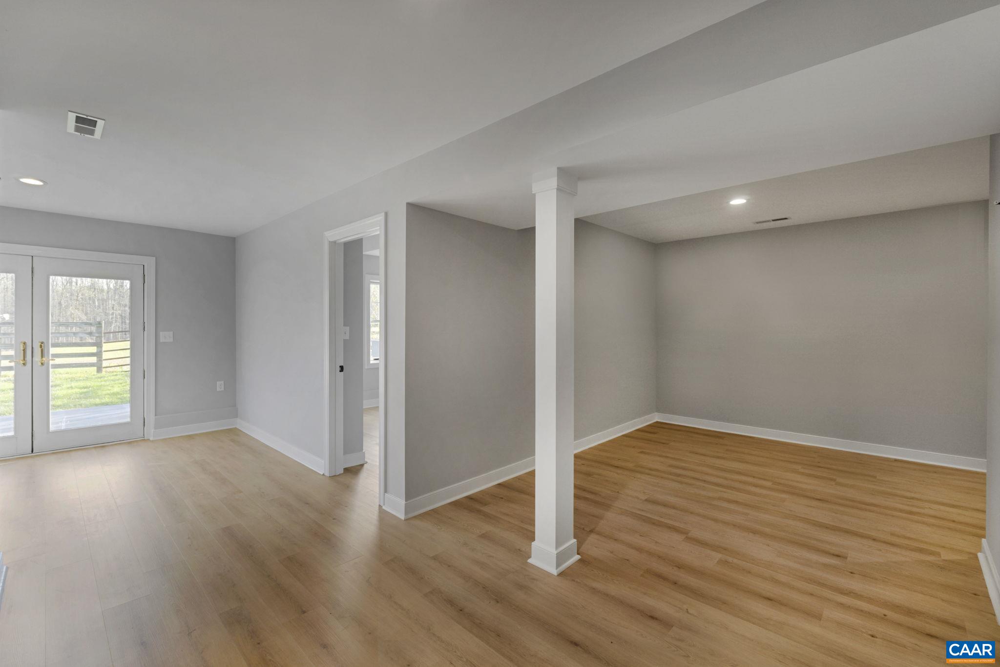 912 Shores Road Palmyra, VA 22963 - Photo 55 of 75 an empty room with wooden floor and windows