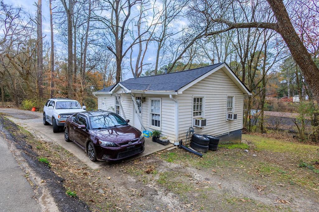 a front view of a house with a garden and parking space