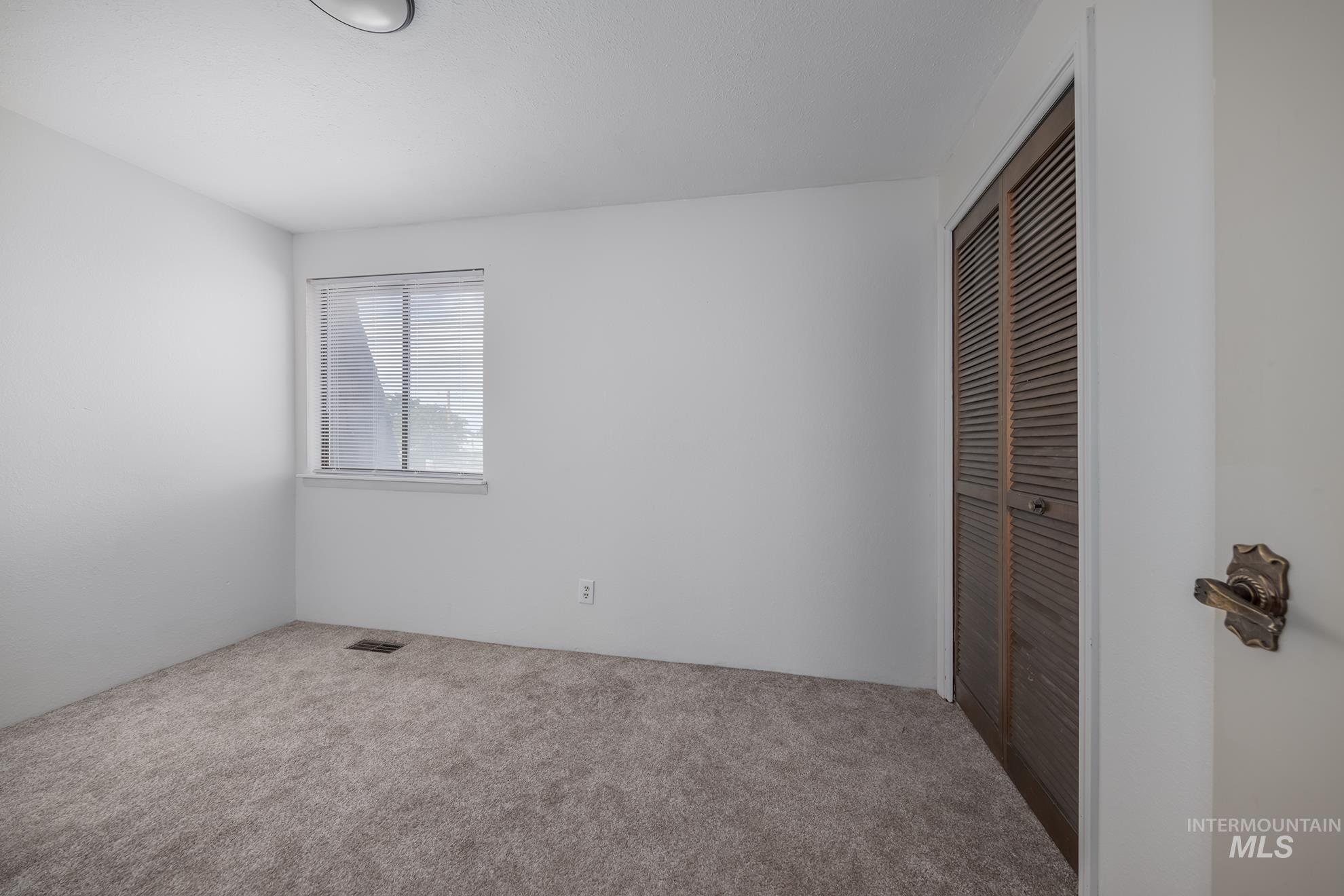 61 Southwest 4th Street Ontario, OR 97914 - Photo 21 of 42 Neutral-toned carpeting complements bright white walls