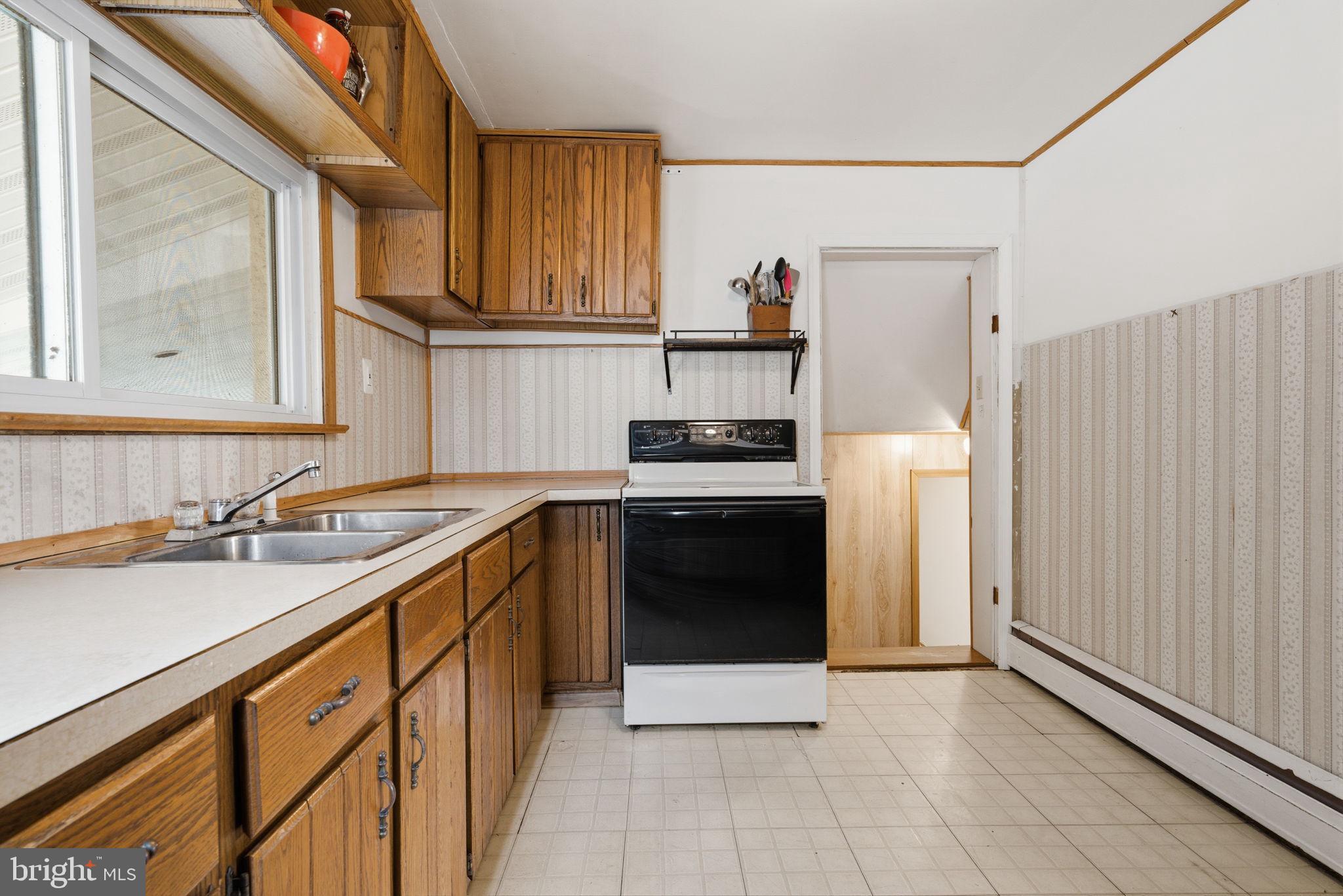 3517 Bristol Road Bensalem, PA 19020 - Photo 12 of 35 a kitchen with a sink stove and cabinets