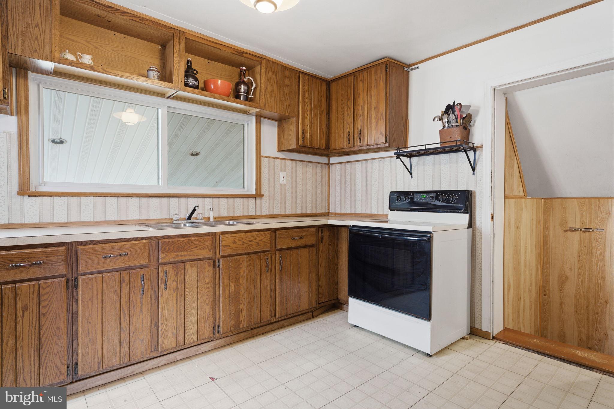 3517 Bristol Road Bensalem, PA 19020 - Photo 9 of 35 a kitchen with stainless steel appliances granite countertop a sink and cabinets with wooden floor