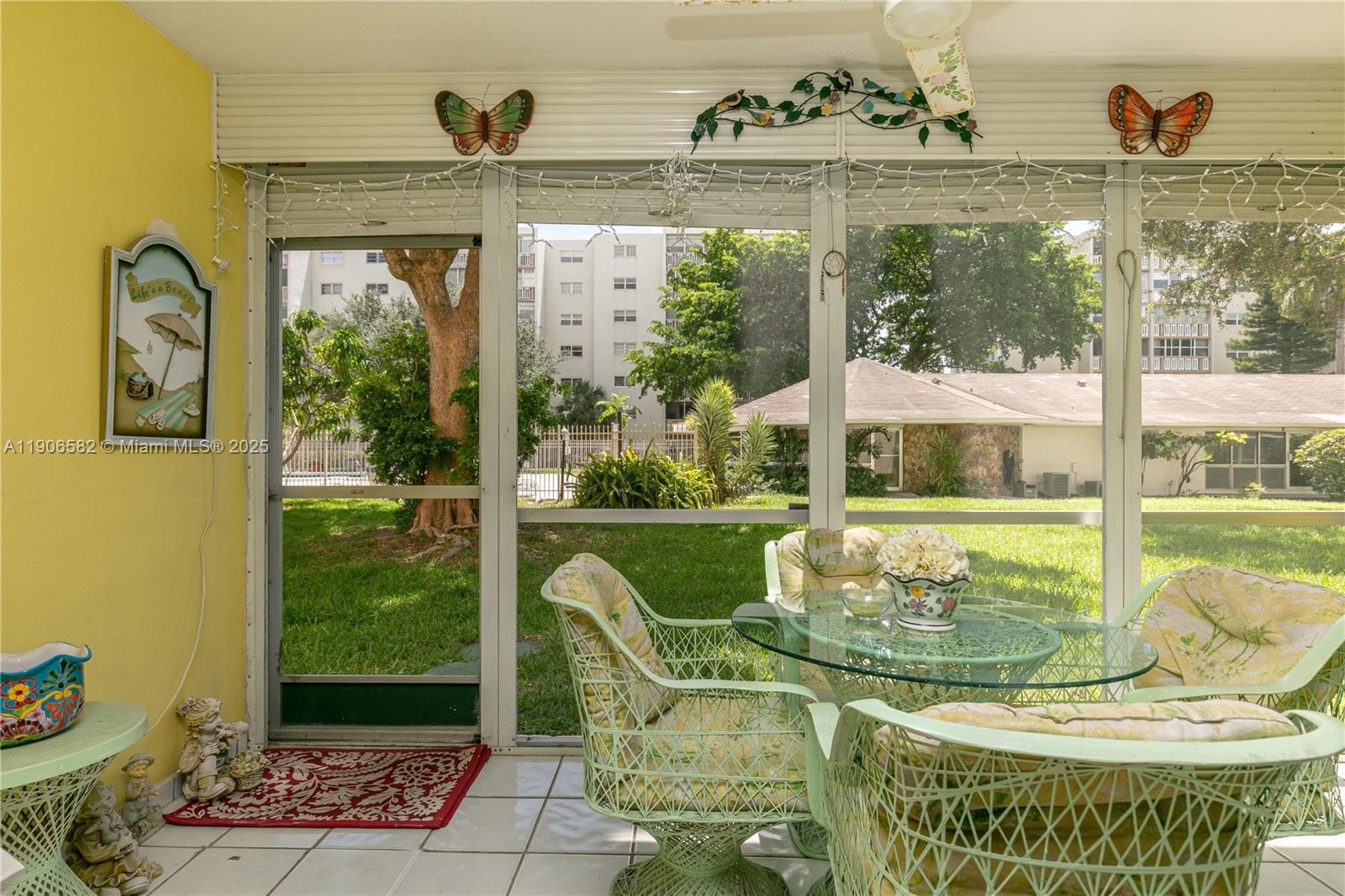1001 Northeast 14th Avenue, Unit 107 Hallandale Beach, FL 33009 - Photo 11 of 28 a view of a porch with furniture and garden view