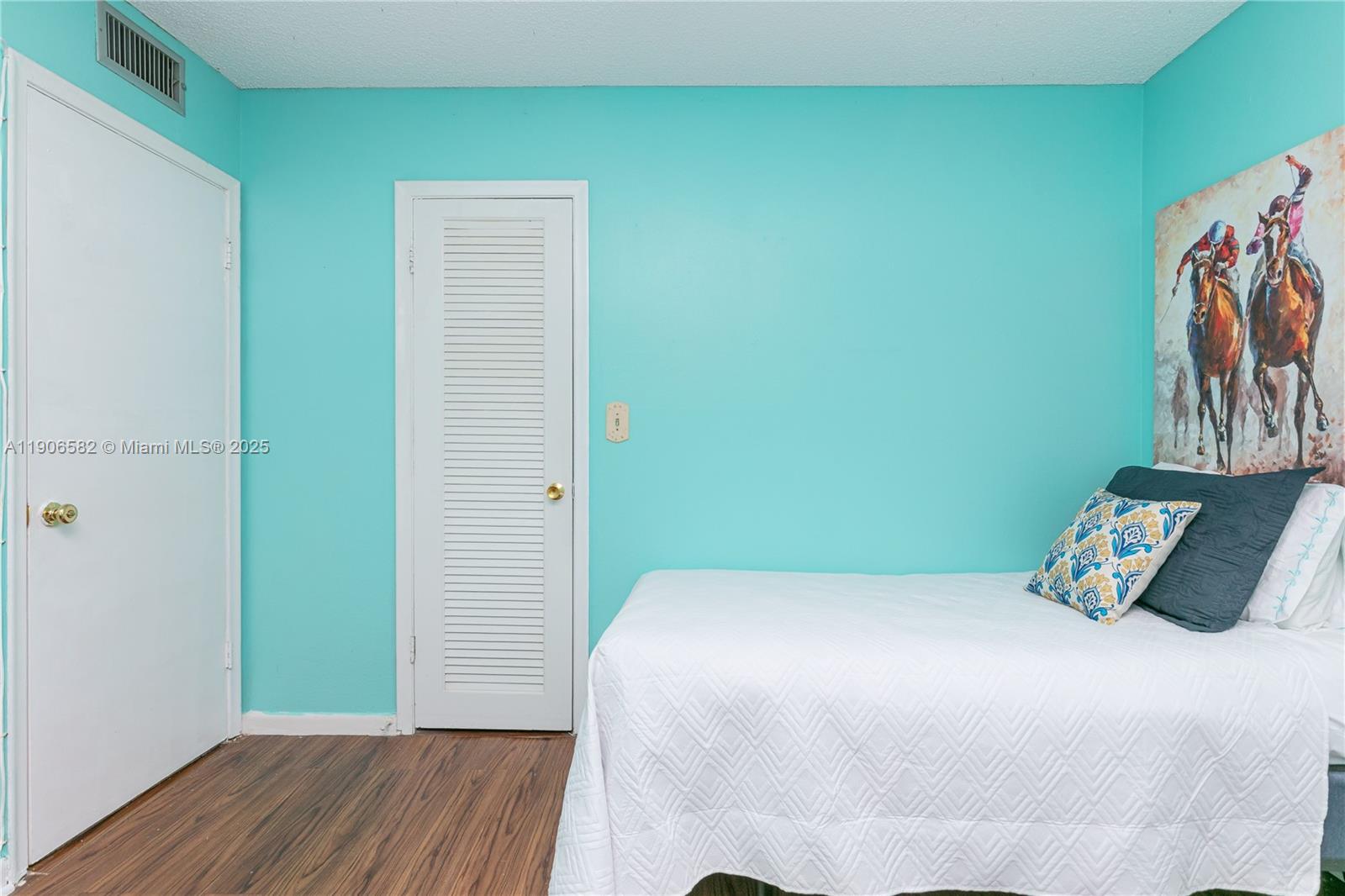 1001 Northeast 14th Avenue, Unit 107 Hallandale Beach, FL 33009 - Photo 14 of 28 a bedroom with a bed and a wall painting