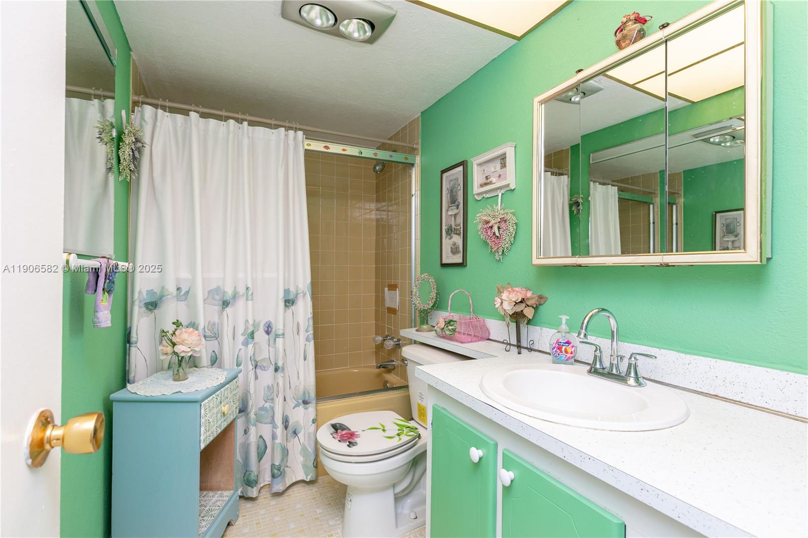 1001 Northeast 14th Avenue, Unit 107 Hallandale Beach, FL 33009 - Photo 15 of 28 a bathroom with a granite countertop sink and a mirror