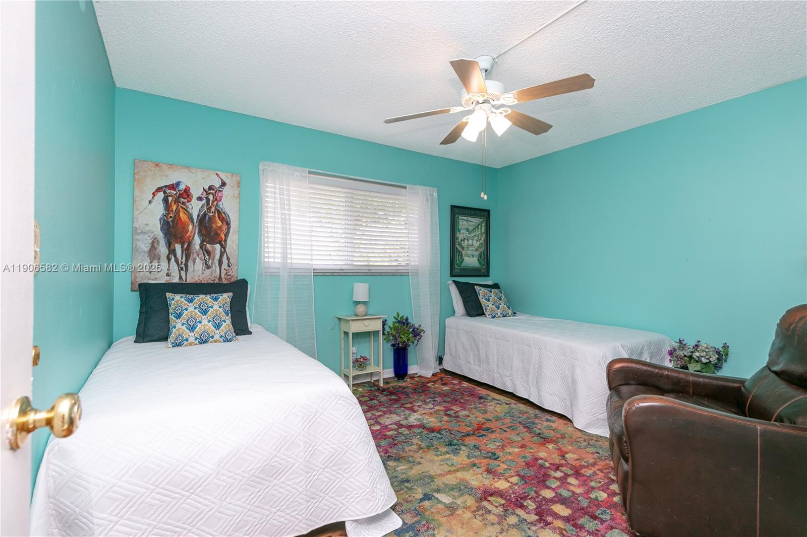 1001 Northeast 14th Avenue, Unit 107 Hallandale Beach, FL 33009 - Photo 17 of 28 a bedroom with a bed and a chandelier