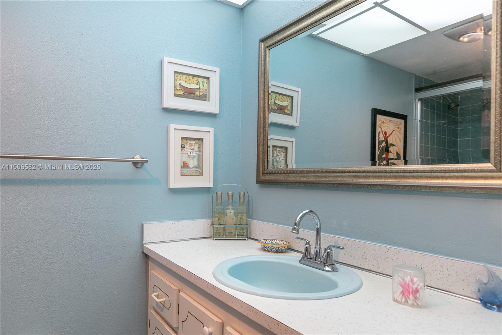 1001 Northeast 14th Avenue, Unit 107 Hallandale Beach, FL 33009 - Photo 18 of 28 a bathroom with a sink and a mirror