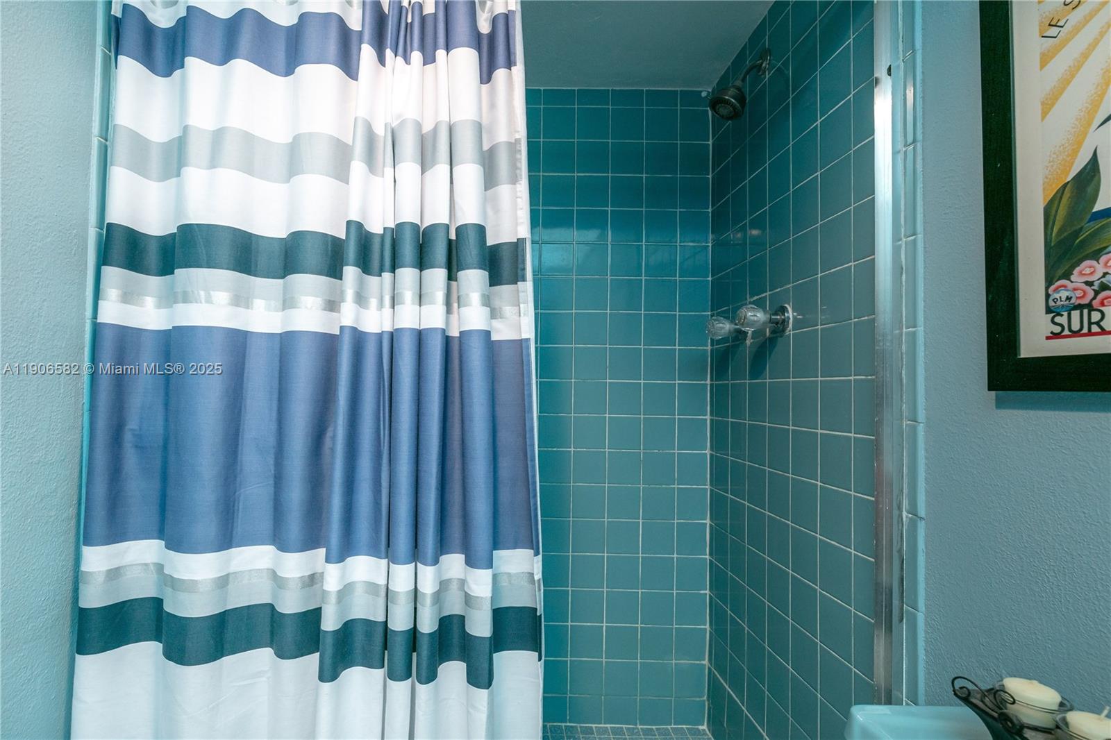 1001 Northeast 14th Avenue, Unit 107 Hallandale Beach, FL 33009 - Photo 20 of 28 a bathroom with a shower curtain
