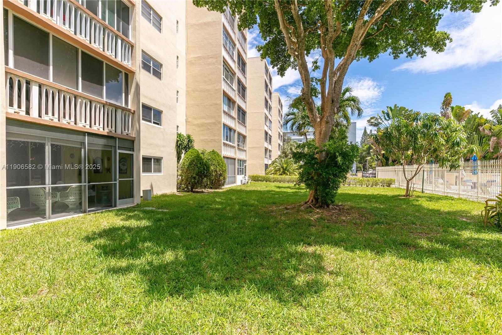 1001 Northeast 14th Avenue, Unit 107 Hallandale Beach, FL 33009 - Photo 21 of 28 a view of a building with a yard