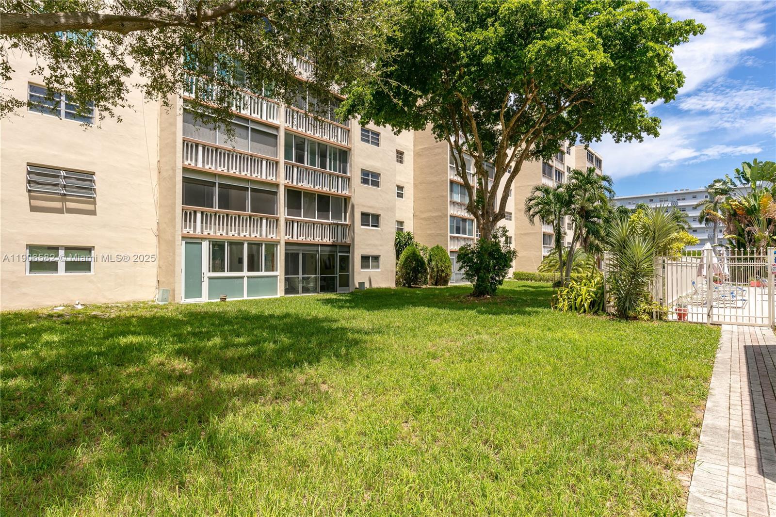 1001 Northeast 14th Avenue, Unit 107 Hallandale Beach, FL 33009 - Photo 23 of 28 front view of a building with a yard