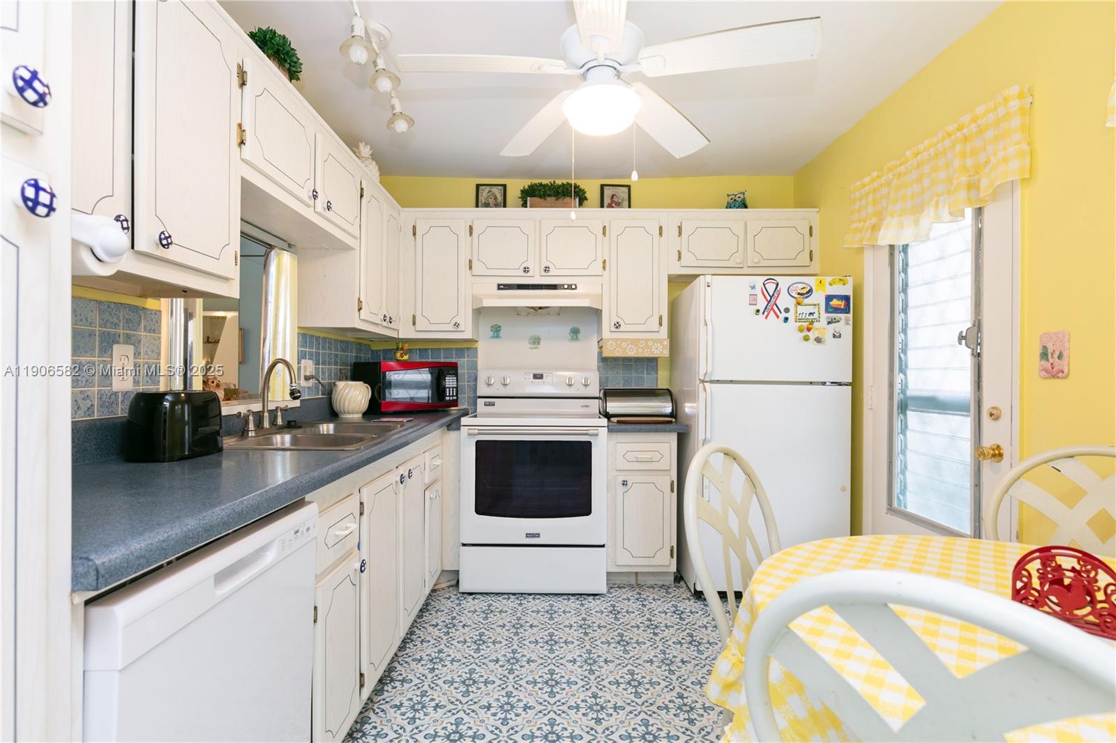 1001 Northeast 14th Avenue, Unit 107 Hallandale Beach, FL 33009 - Photo 6 of 28 a kitchen with stainless steel appliances a refrigerator sink and cabinets