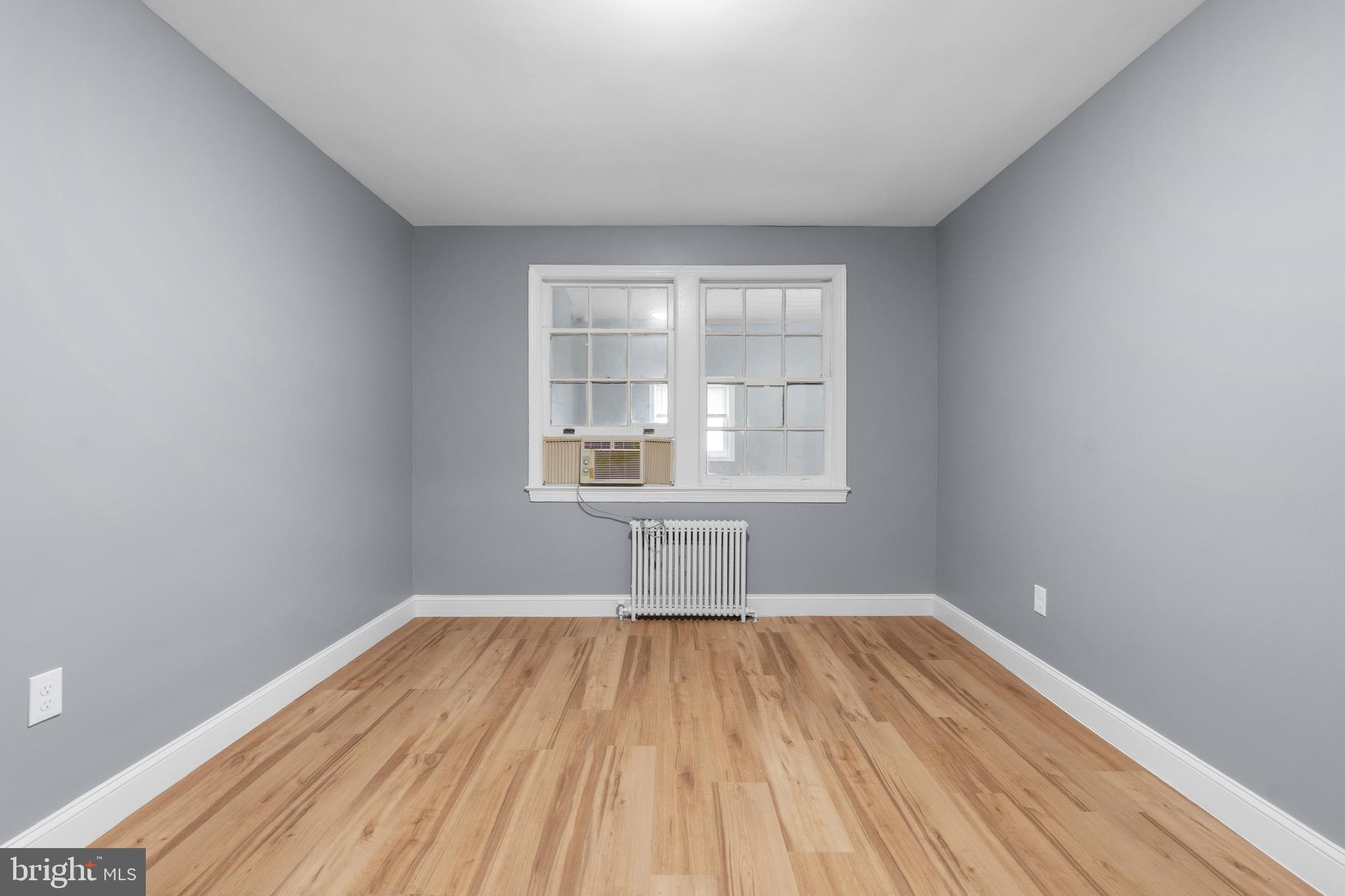 1721 29th Street Southeast, Unit 1 Washington, DC 20020 - Photo 13 of 24 a view of a room with wooden floor and windows