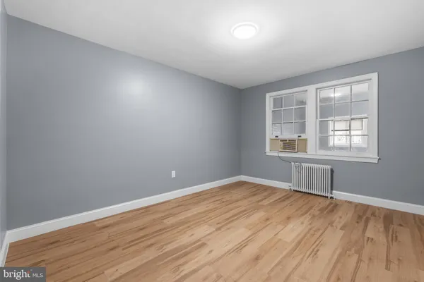 a view of a room with wooden floor and windows