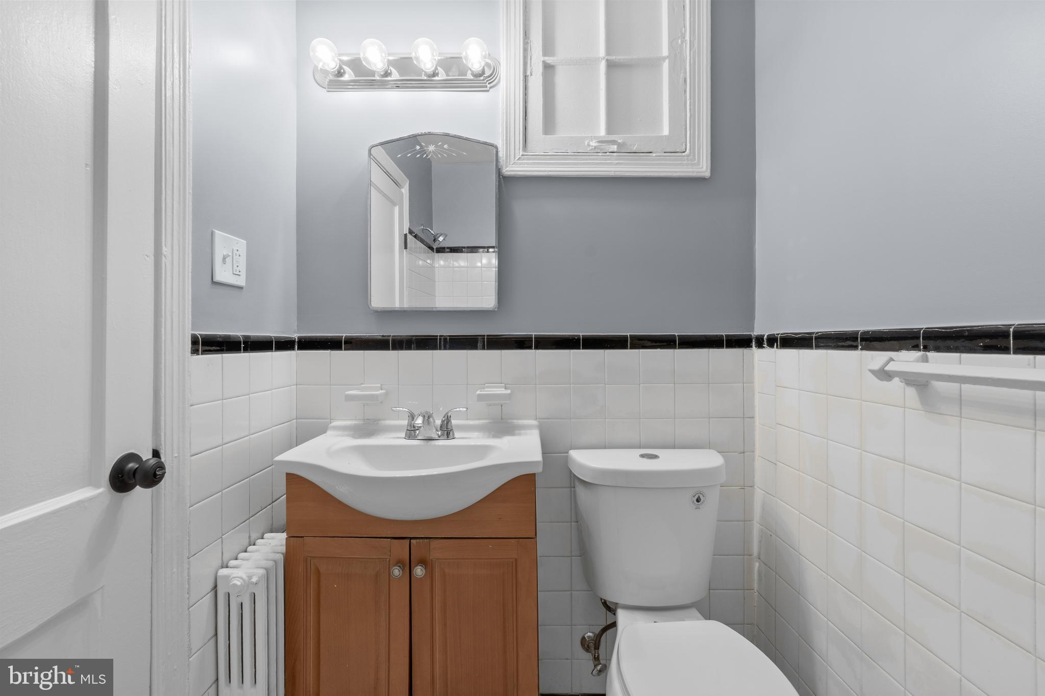 1721 29th Street Southeast, Unit 1 Washington, DC 20020 - Photo 16 of 24 a bathroom with a toilet sink and mirror
