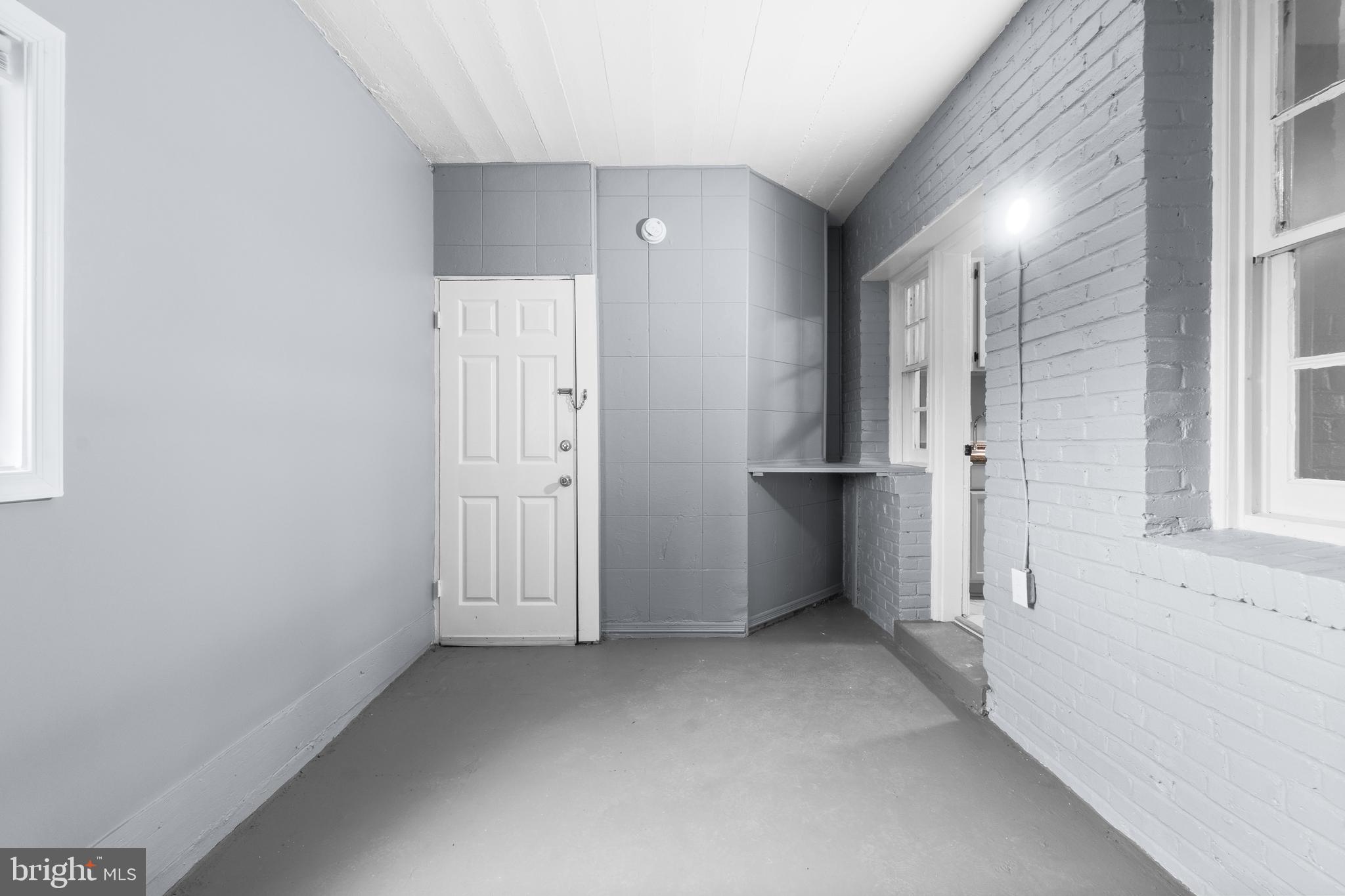 1721 29th Street Southeast, Unit 1 Washington, DC 20020 - Photo 18 of 24 an empty room with entrance and windows