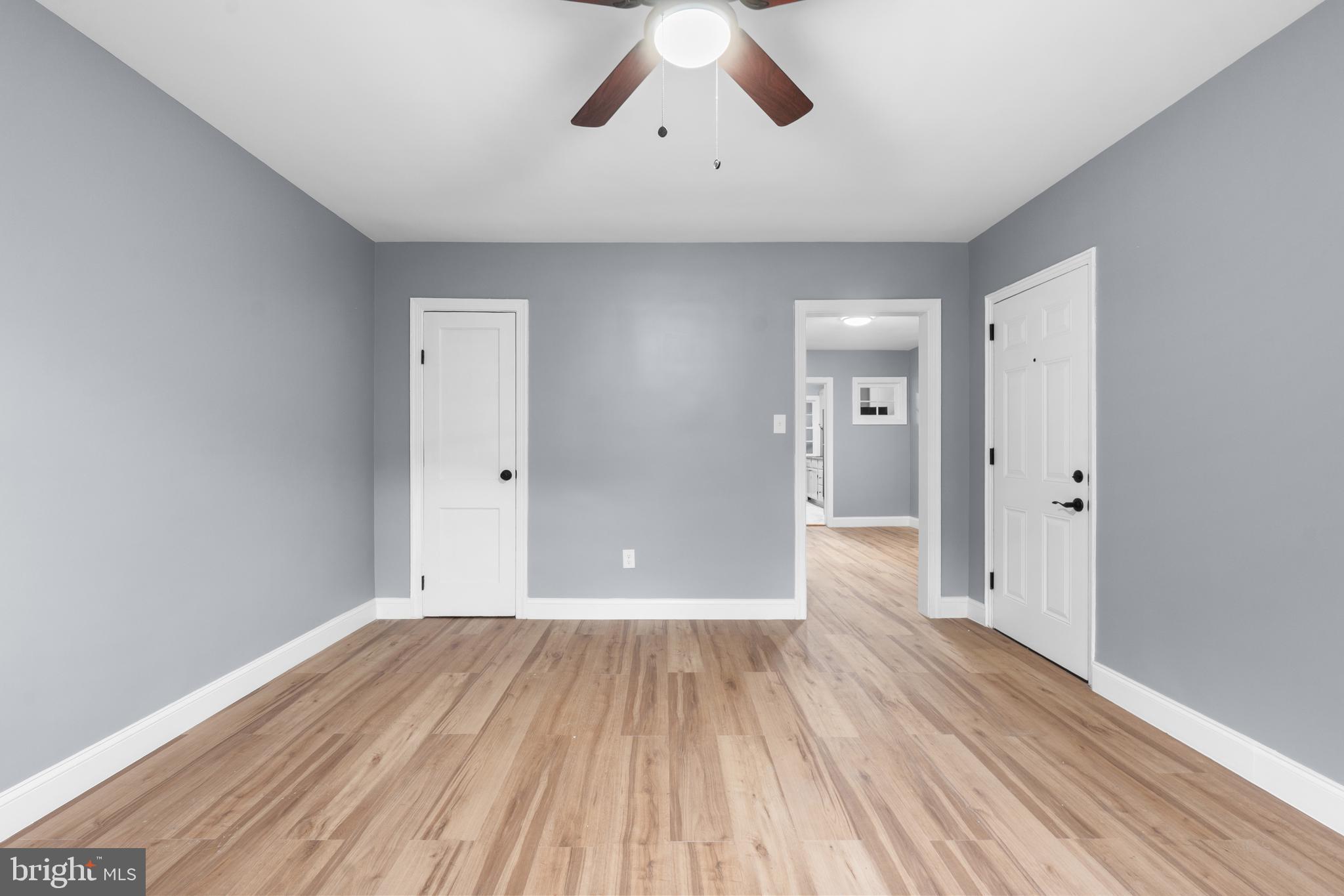 1721 29th Street Southeast, Unit 1 Washington, DC 20020 - Photo 3 of 24 a view of a big room with wooden floor and a ceiling fan