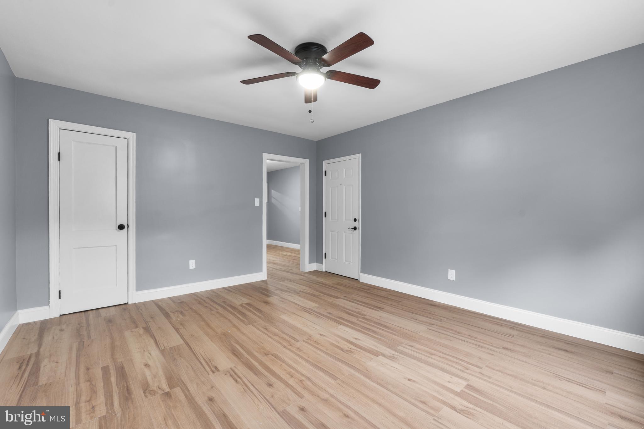 1721 29th Street Southeast, Unit 1 Washington, DC 20020 - Photo 4 of 24 an empty room with wooden floor and ceiling fan