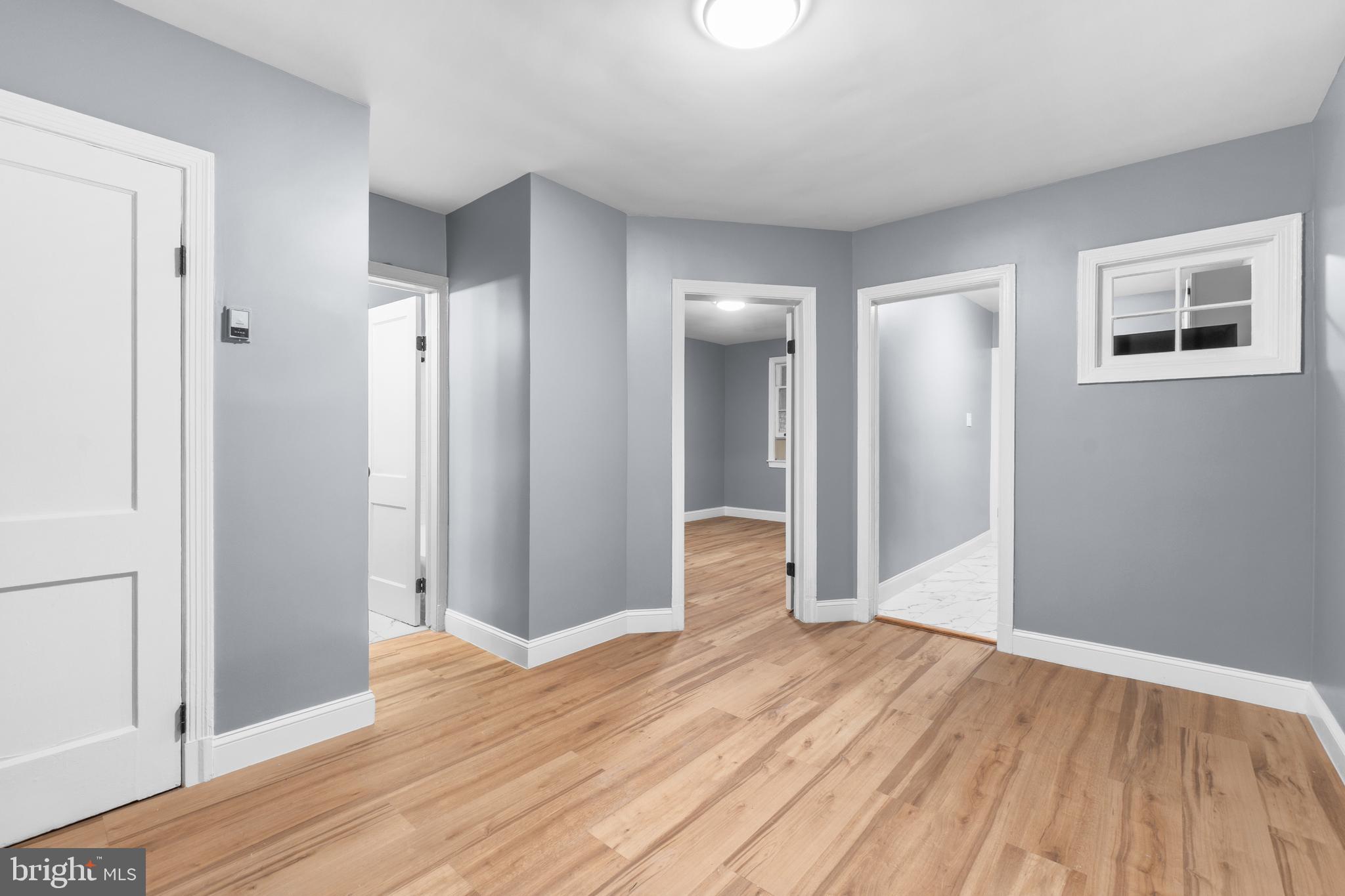 1721 29th Street Southeast, Unit 1 Washington, DC 20020 - Photo 9 of 24 wooden floor in an empty room with a window