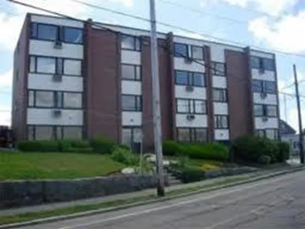 a view of a brick building next to a yard