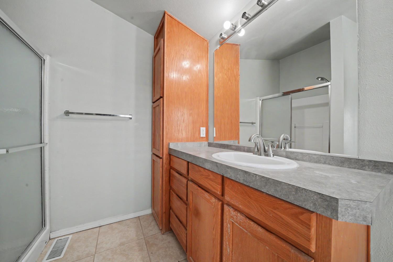 3155 Hawver Road San Andreas, CA 95249 - Photo 33 of 63 Primary bathroom shower and sink cabinetry.