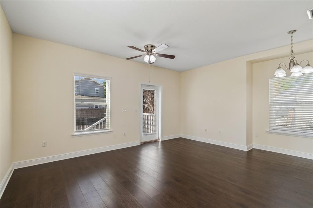 2322 West Chestnut Street Tampa, FL 33607 - Photo 12 of 27 a view of an empty room with wooden floor and a window