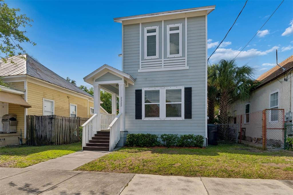 2322 West Chestnut Street Tampa, FL 33607 - Photo 2 of 27 a front view of a house with a yard and garage