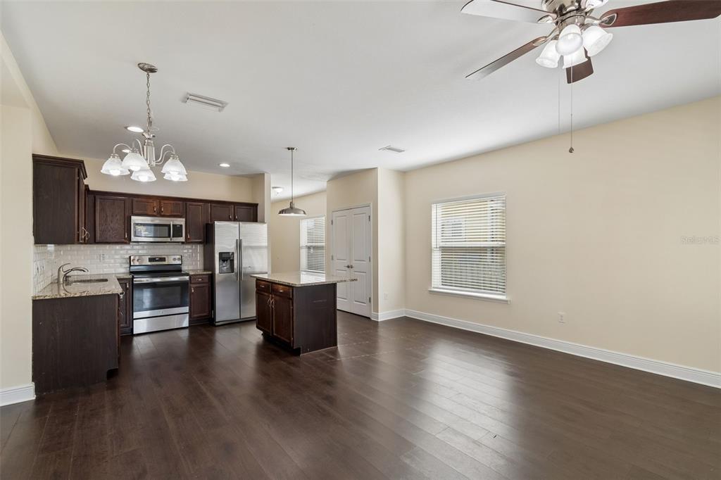 2322 West Chestnut Street Tampa, FL 33607 - Photo 6 of 27 a view of a kitchen with a sink wooden floor and a refrigerator