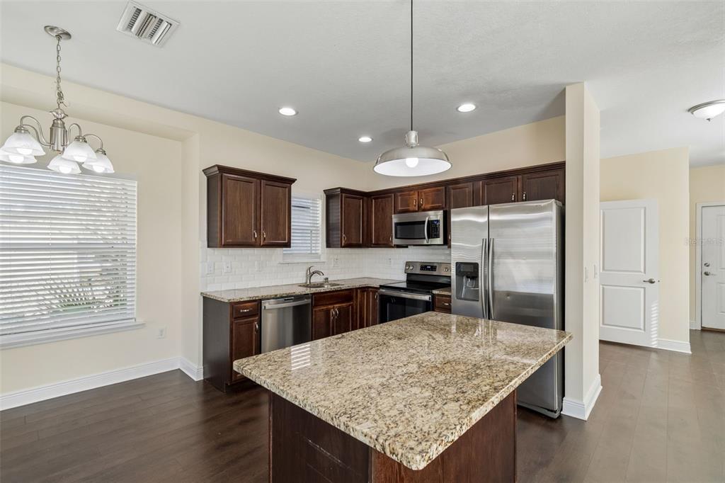 2322 West Chestnut Street Tampa, FL 33607 - Photo 7 of 27 a kitchen with stainless steel appliances granite countertop counter space a refrigerator and stove