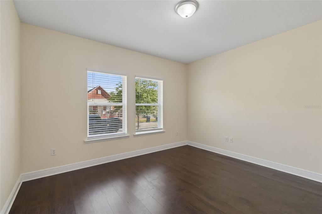 2322 West Chestnut Street Tampa, FL 33607 - Photo 10 of 27 an empty room with wooden floor and windows