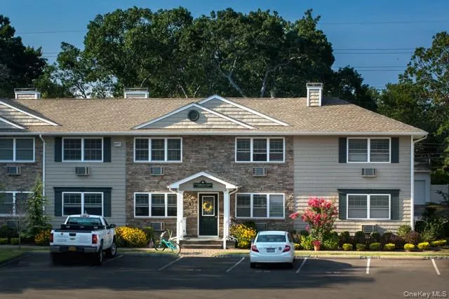 a front view of a house with a garden and plants