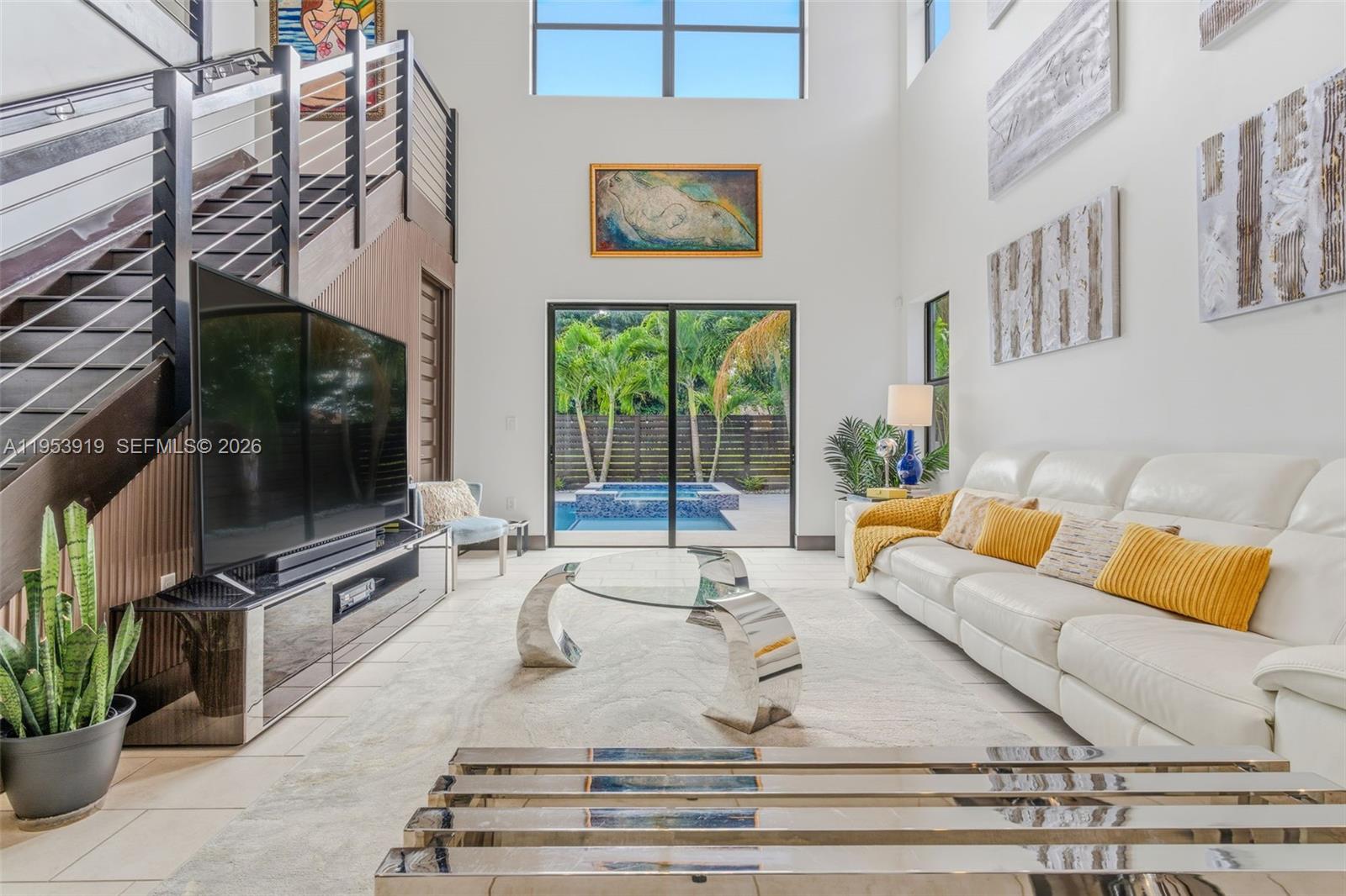 16044 Southwest 136 Way Miami, FL 33196 - Photo 15 of 64 a living room with furniture a flat screen tv and a fireplace