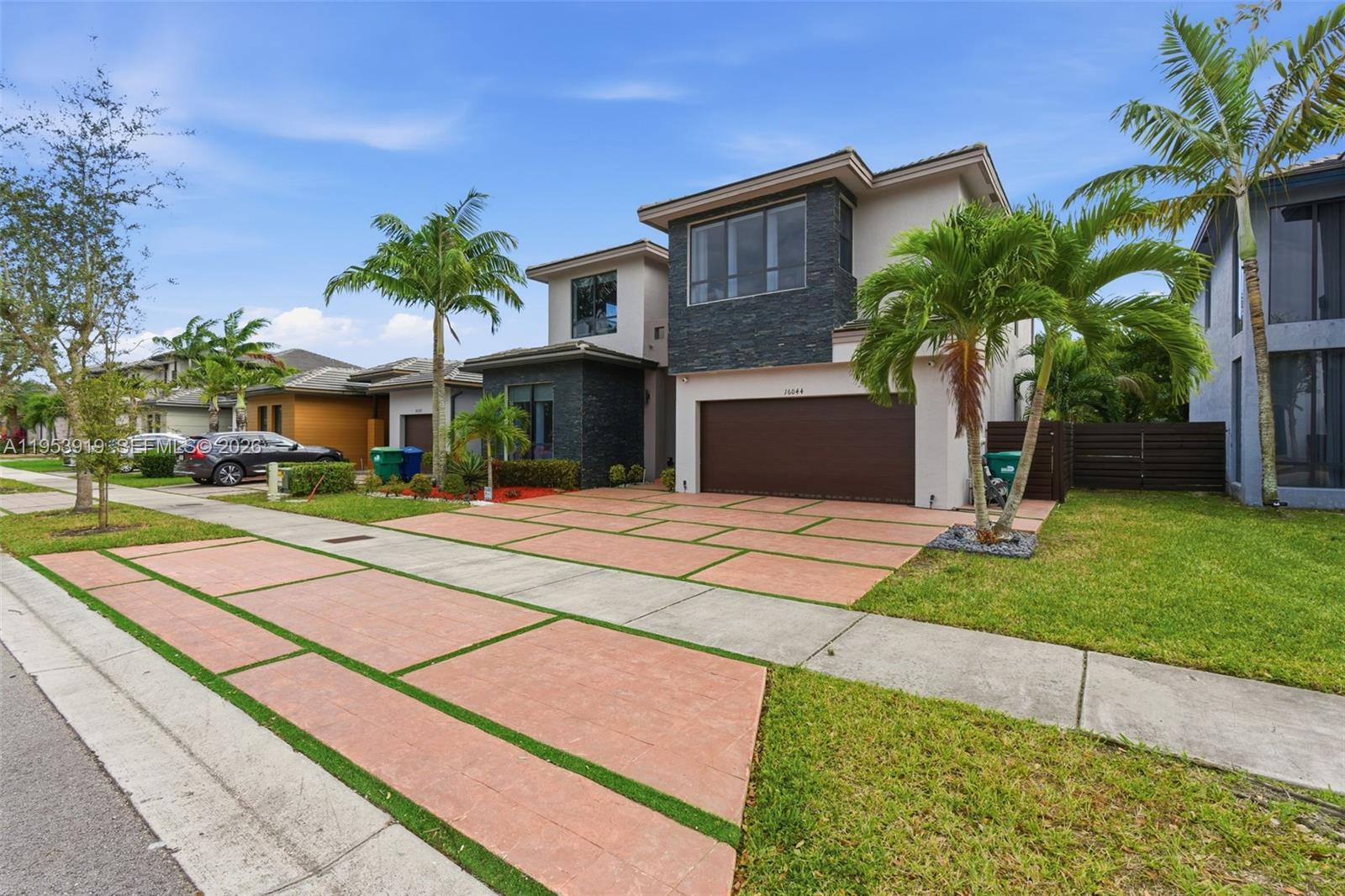 16044 Southwest 136 Way Miami, FL 33196 - Photo 2 of 64 a front view of a house with a yard and potted plants
