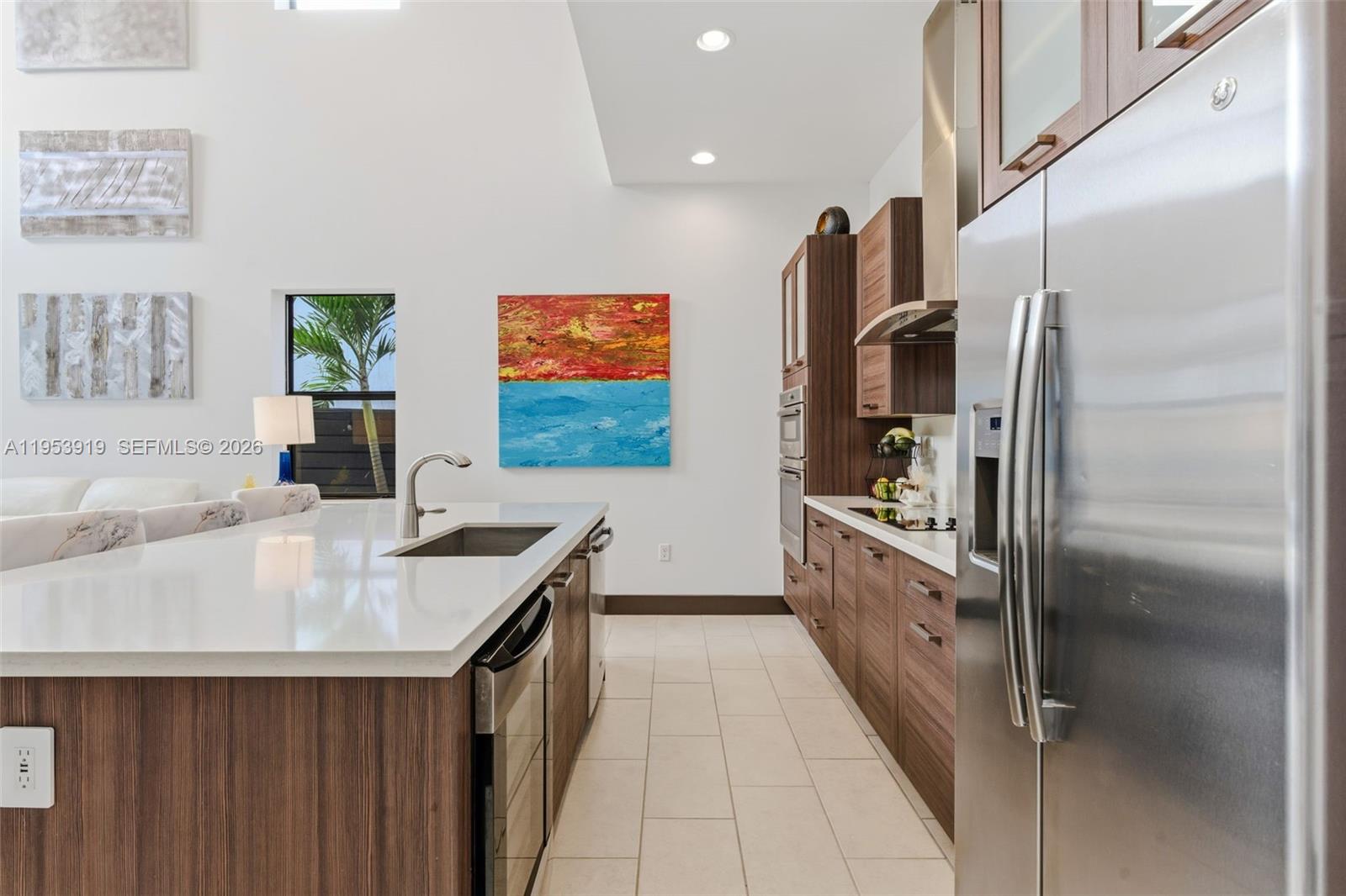 16044 Southwest 136 Way Miami, FL 33196 - Photo 22 of 64 a kitchen with stainless steel appliances granite countertop a sink and a refrigerator