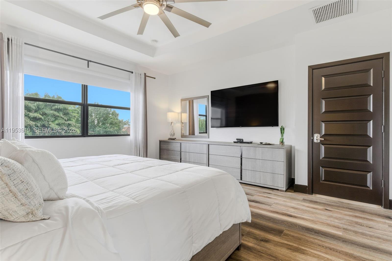 16044 Southwest 136 Way Miami, FL 33196 - Photo 24 of 64 a bedroom with a bed and a flat screen tv