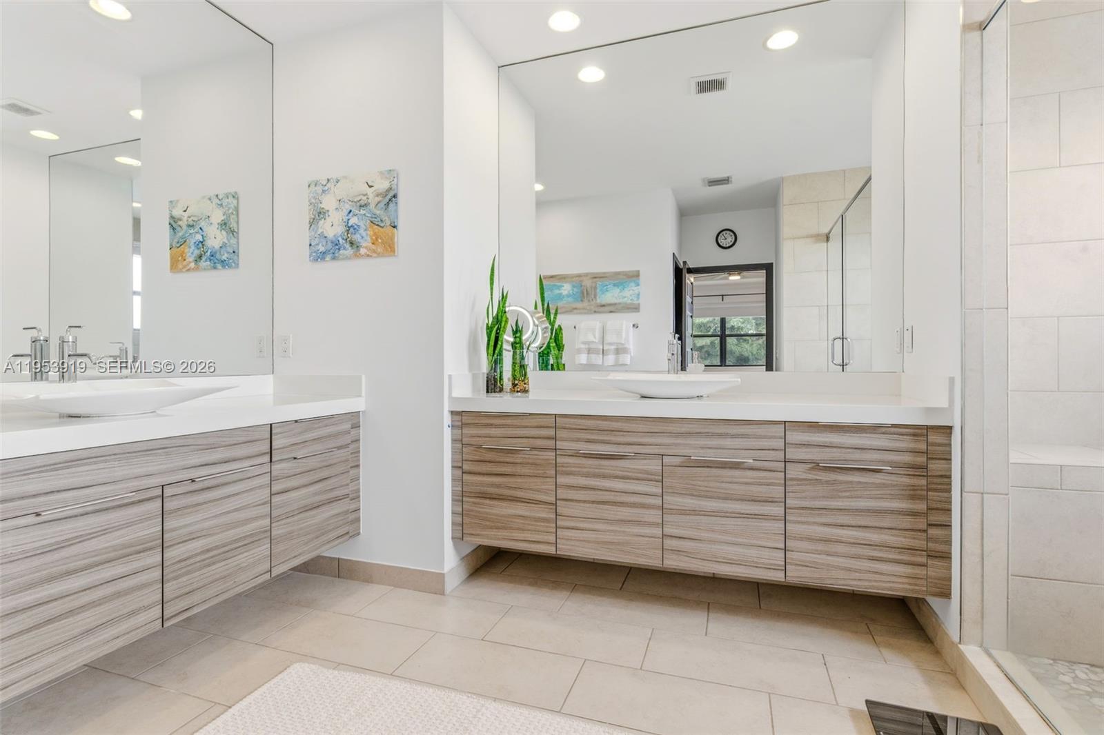 16044 Southwest 136 Way Miami, FL 33196 - Photo 27 of 64 a bathroom with a sink vanity and mirror