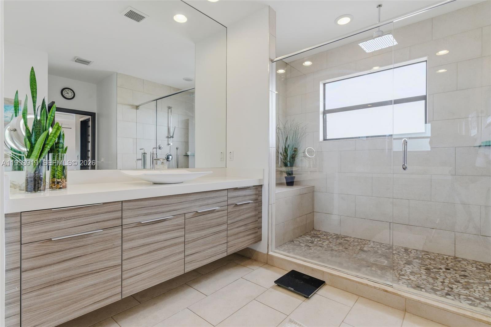 16044 Southwest 136 Way Miami, FL 33196 - Photo 28 of 64 a bathroom with a double vanity sink a mirror and a shower