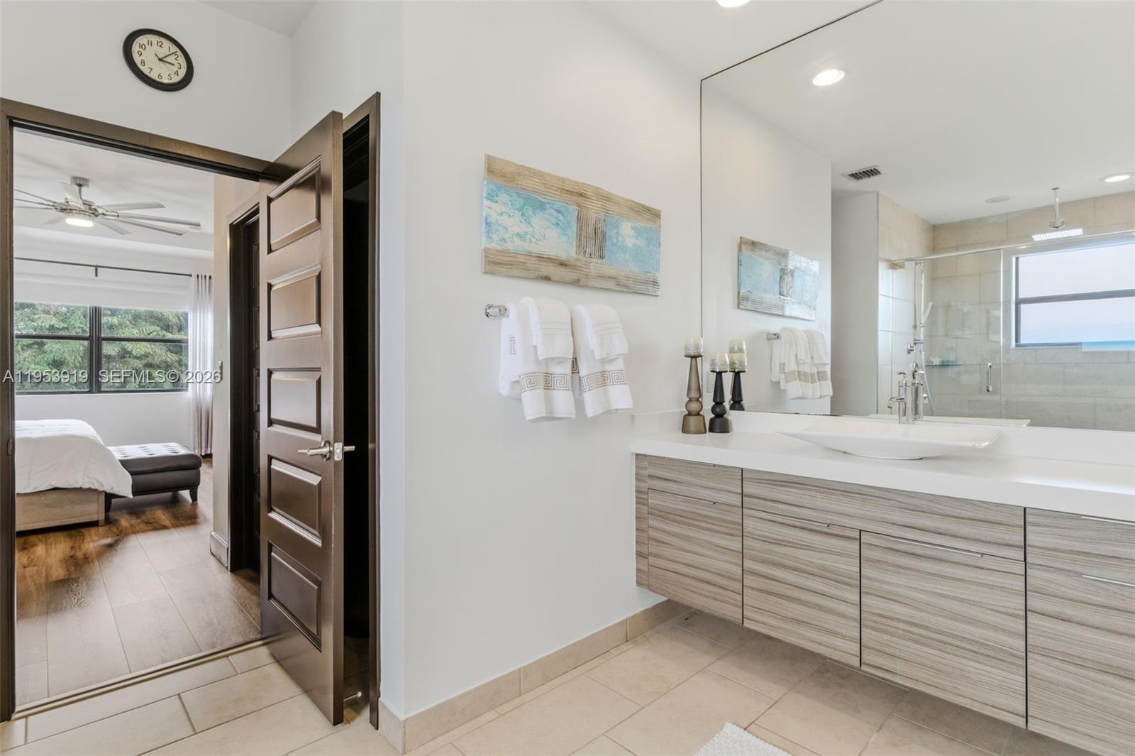 16044 Southwest 136 Way Miami, FL 33196 - Photo 29 of 64 a en suite bathroom with a double vanity sink a mirror and a shower