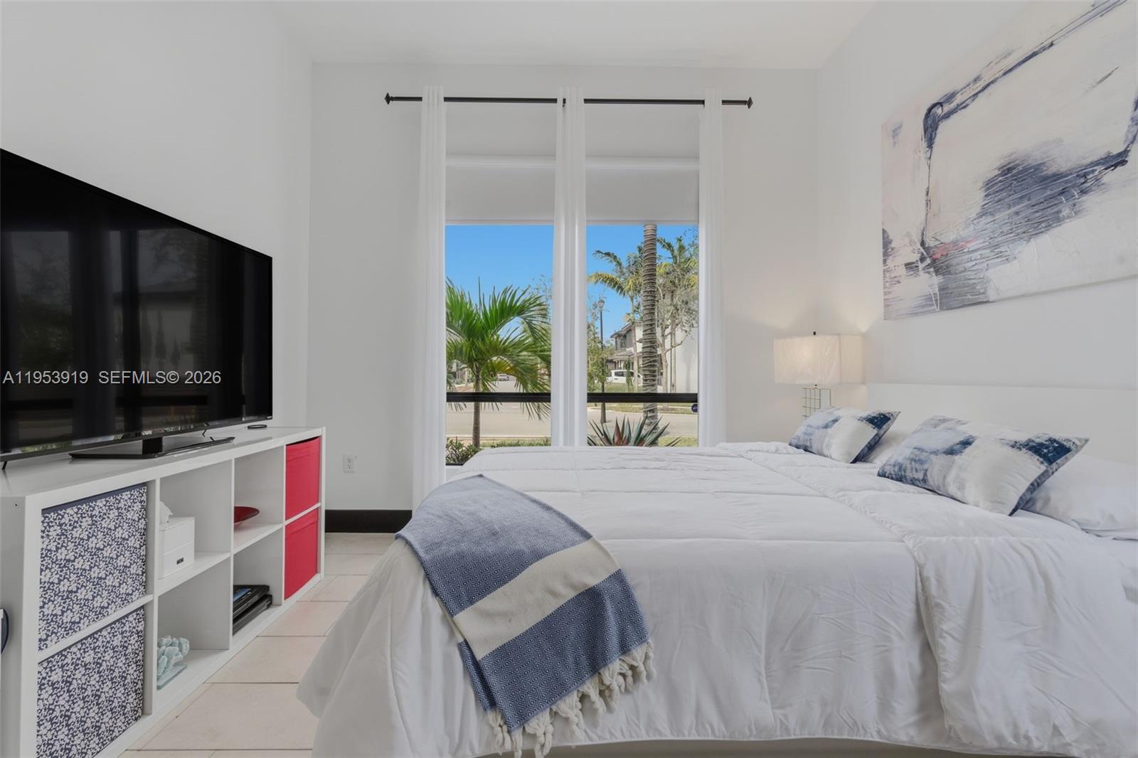 16044 Southwest 136 Way Miami, FL 33196 - Photo 32 of 64 a bedroom with a bed and a flat screen tv