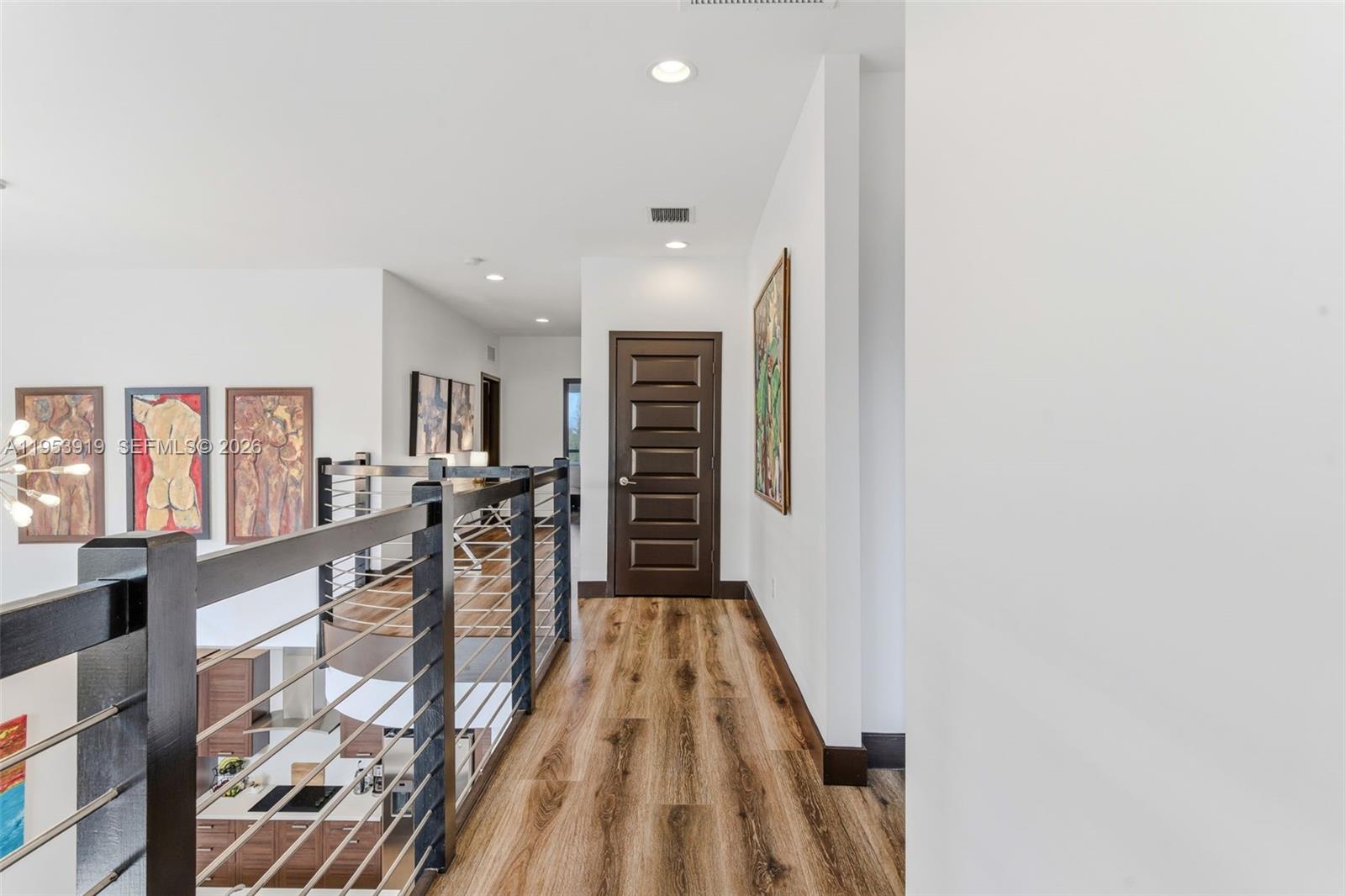 16044 Southwest 136 Way Miami, FL 33196 - Photo 36 of 64 a view of a hallway with wooden floor and furniture