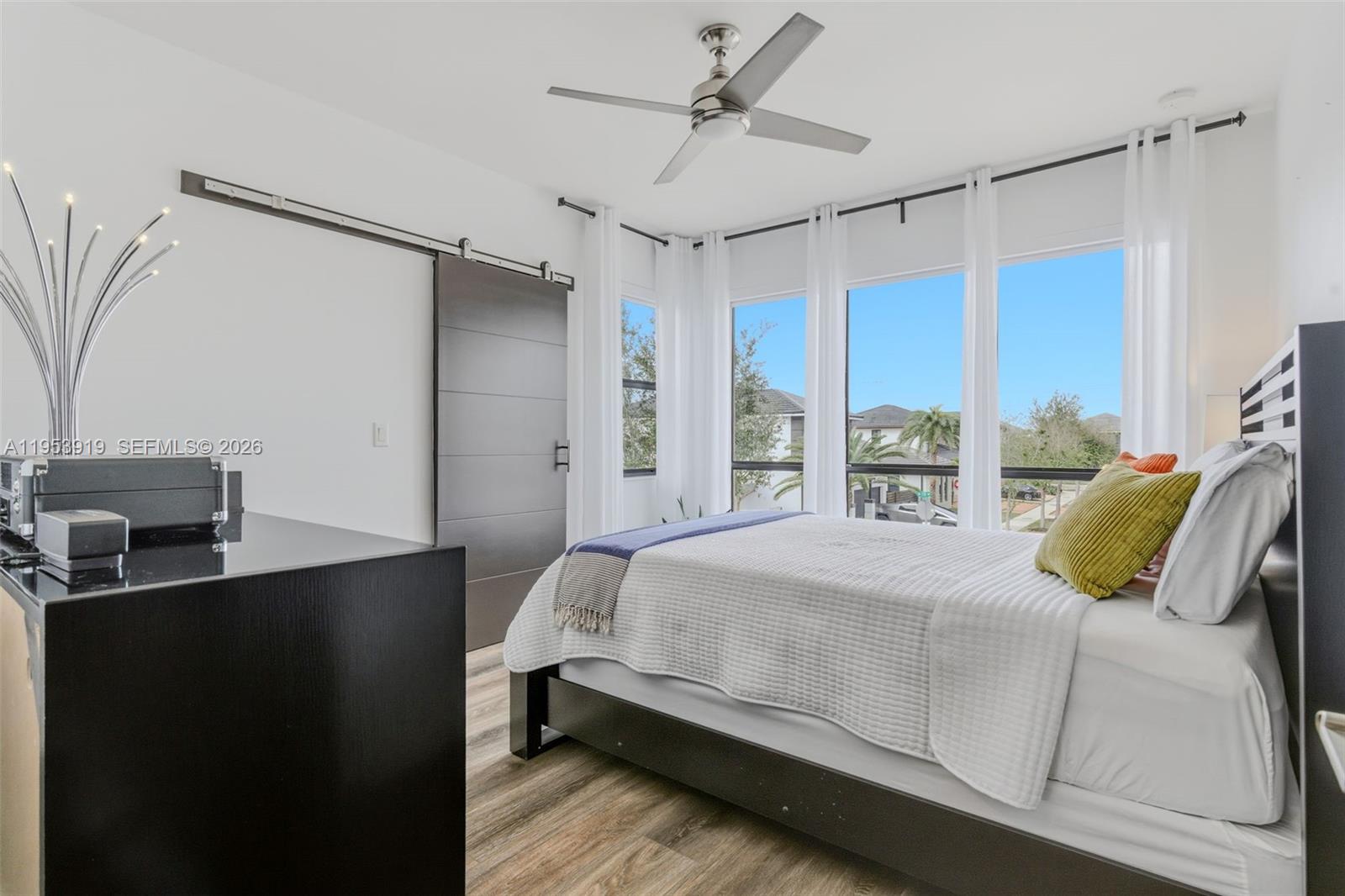 16044 Southwest 136 Way Miami, FL 33196 - Photo 41 of 64 a bedroom with a bed flat screen tv and a window