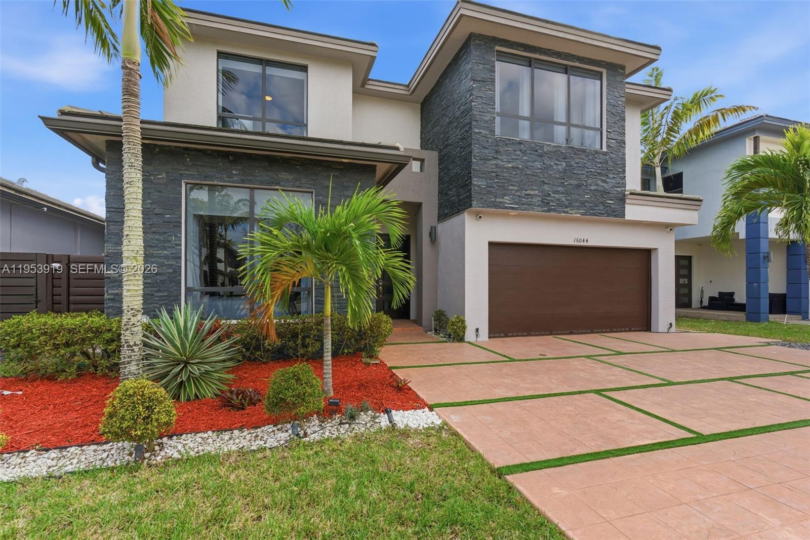 16044 Southwest 136 Way Miami, FL 33196 - Photo 56 of 64 a front view of a house with a yard and garage