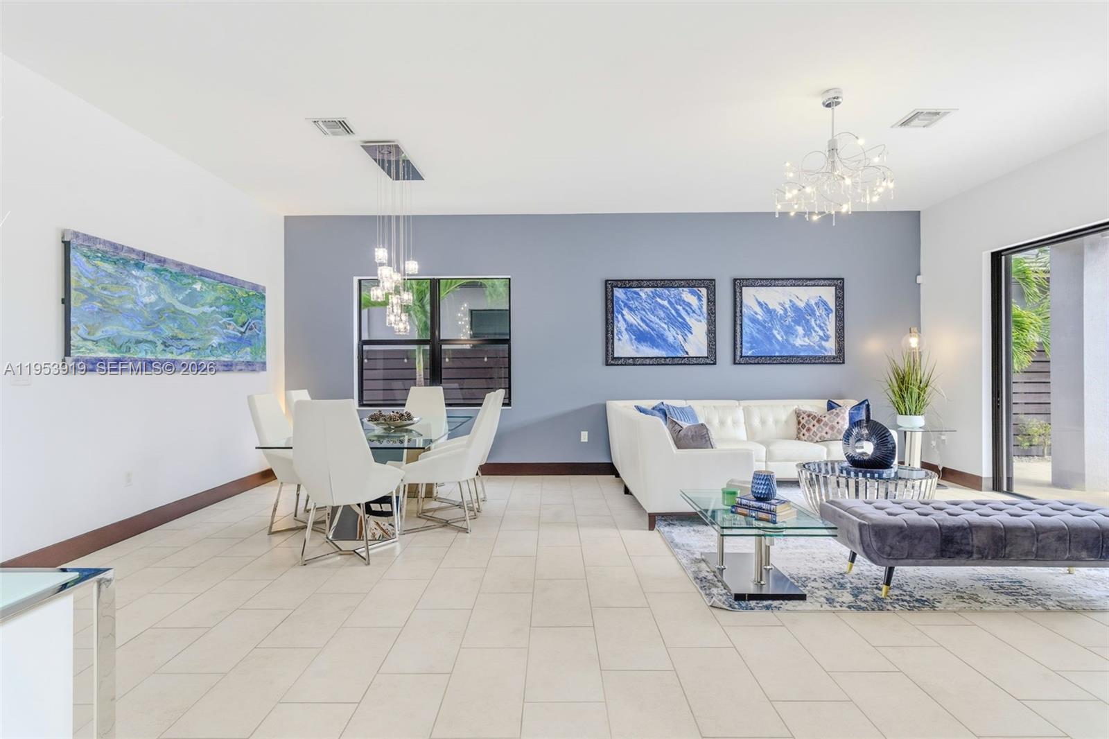 16044 Southwest 136 Way Miami, FL 33196 - Photo 6 of 64 a living room with furniture and a chandelier
