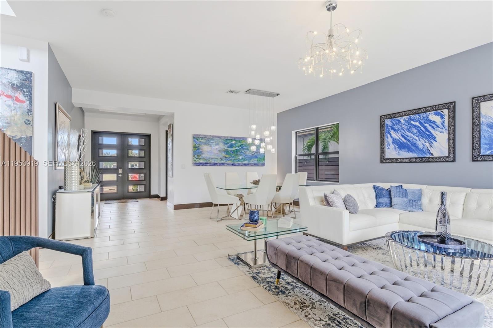 16044 Southwest 136 Way Miami, FL 33196 - Photo 7 of 64 a living room with furniture and a chandelier