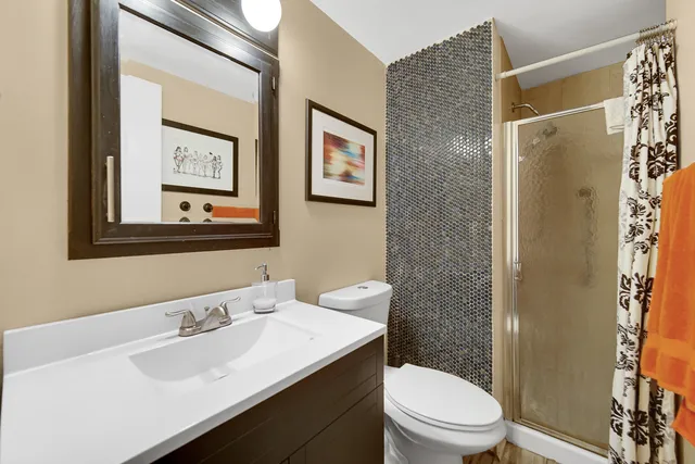 a bathroom with a toilet a sink and a mirror