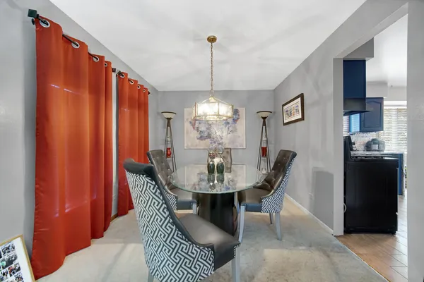 a dining room with furniture and window