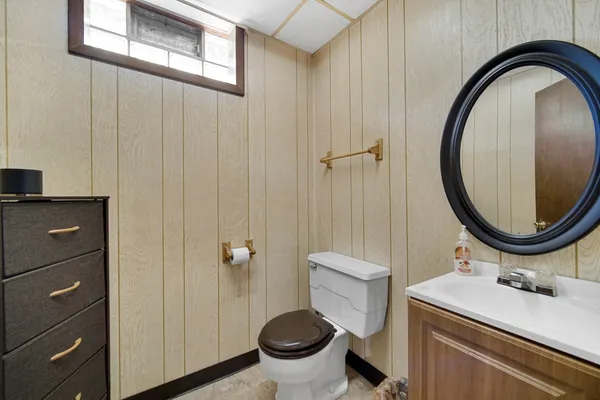 a bathroom with a sink a toilet and a mirror